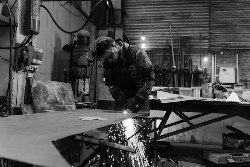 A man cutting steel