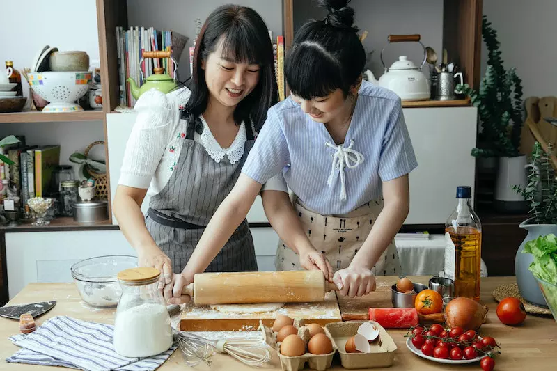 2 lady making roti at home