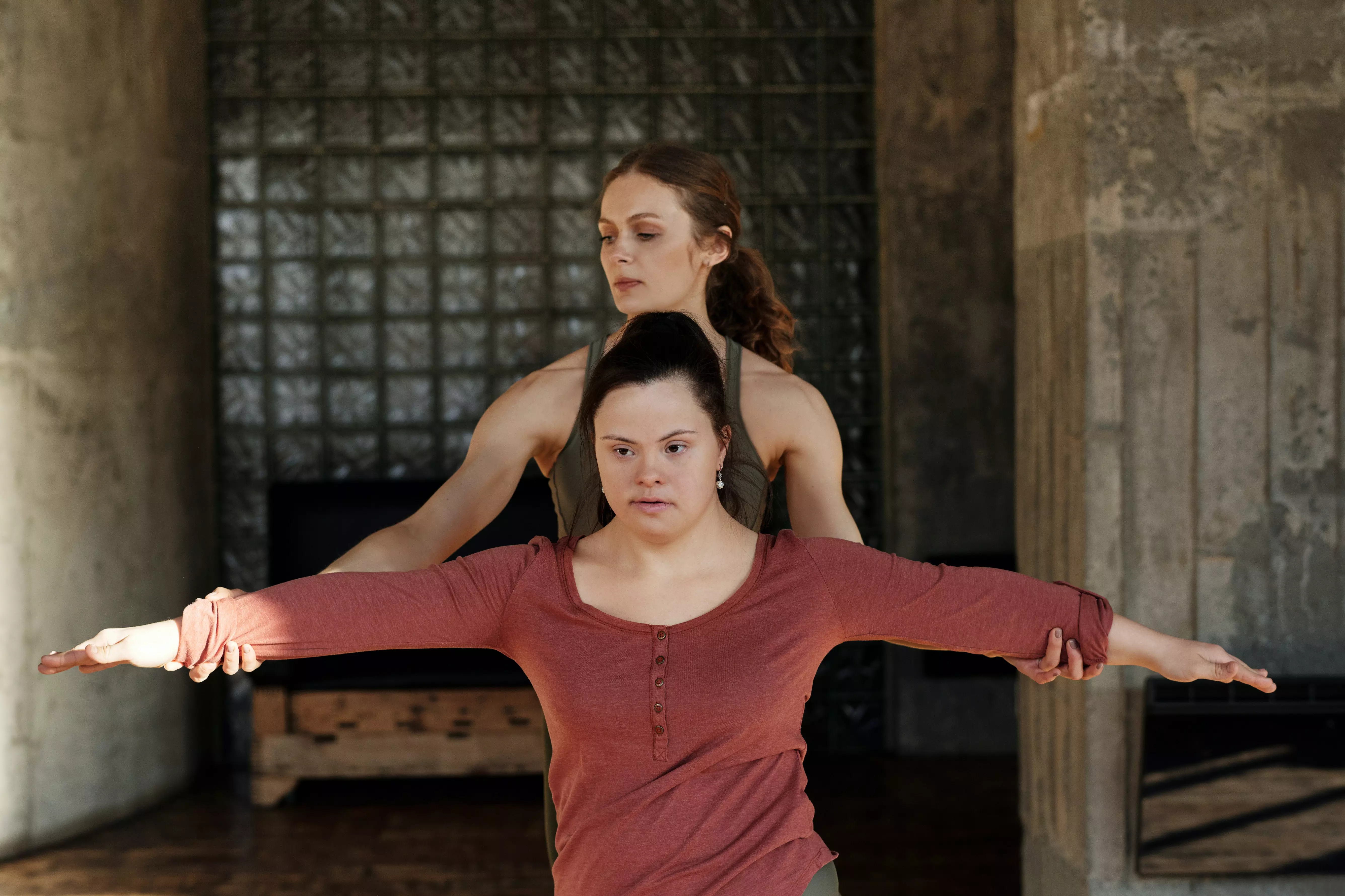 A lady is teaching her clint yoga steps