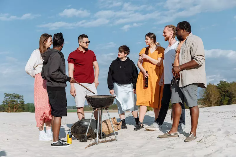 Group of people standing near the barbeau