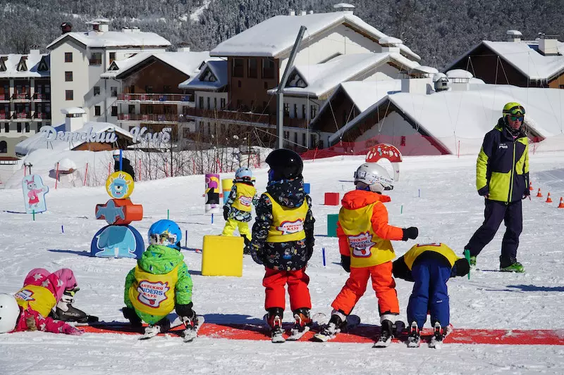 Children skiing on a snow ground