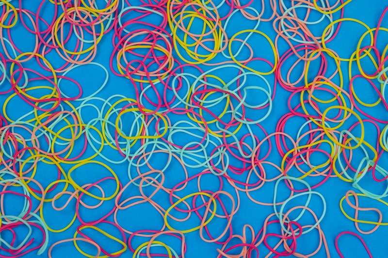 Rubber bands placed on the blue floor.