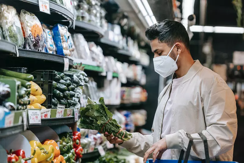 A man buying vegetable from hypermarket 