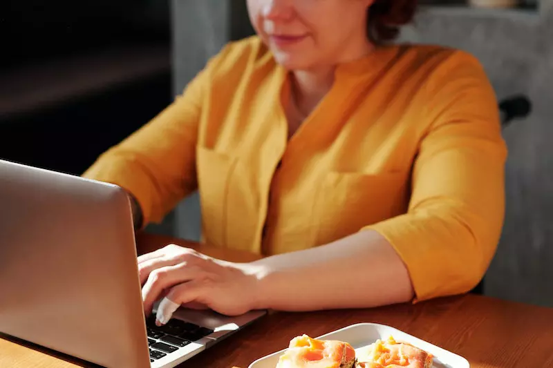A lady is using her laptop 