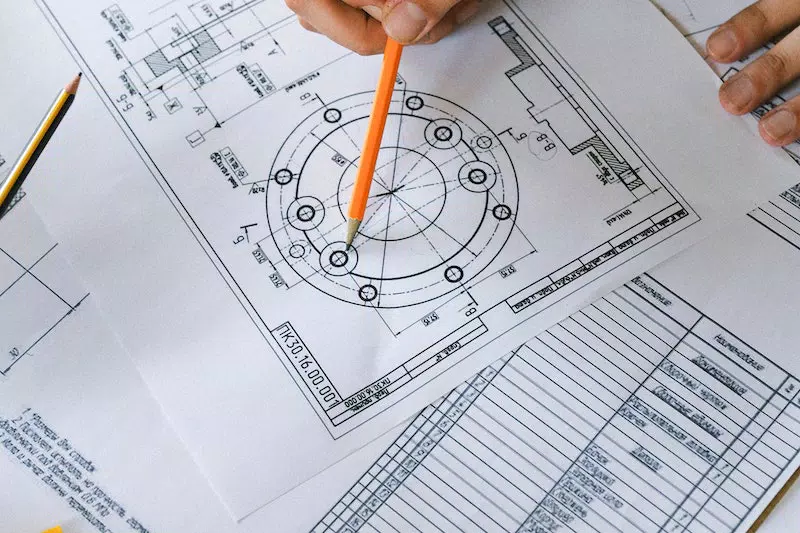 A man making design in the paper
