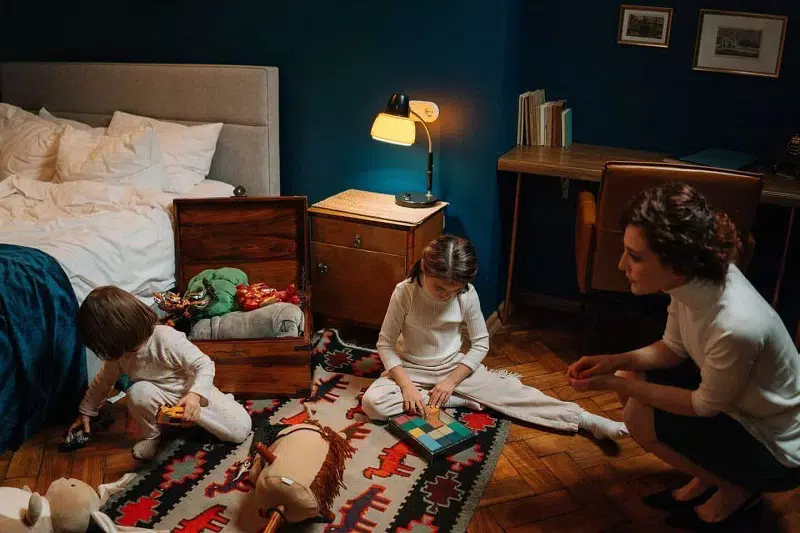 A lady baby sitting on  2 child