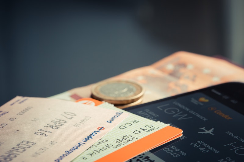 Tickets and some money are placed on the table.