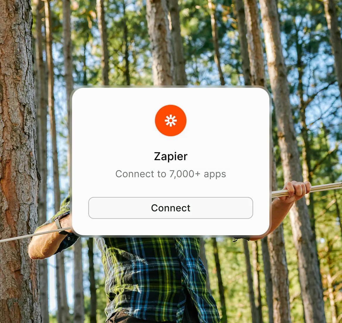 Overlay showing Zapier app connection option with a forest background and a person holding onto a rope.