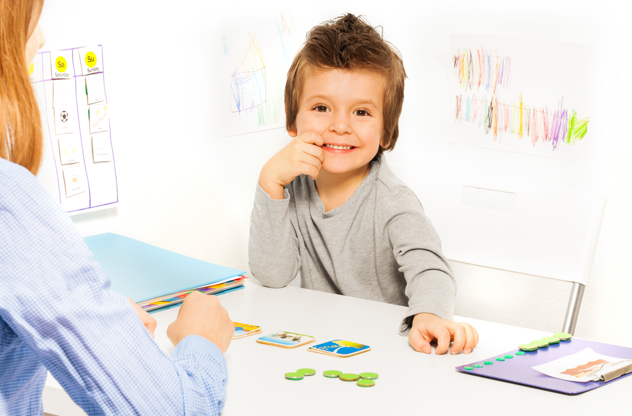 Child smiling during a therapy activity