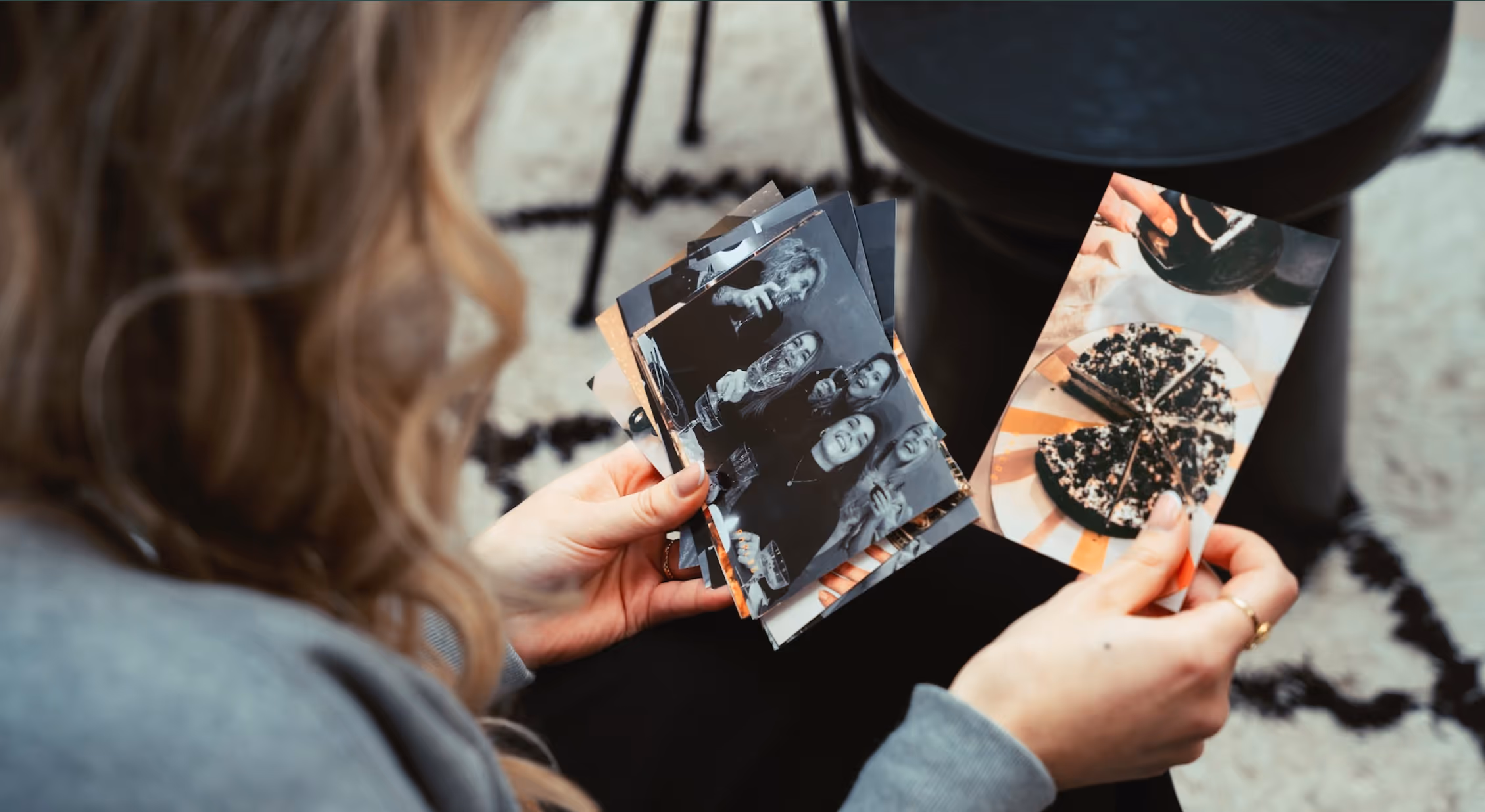 Woman looking through analog printed photos