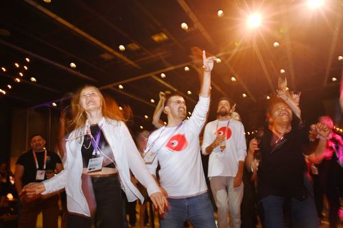 People dancing and celebrating at a lively corporate event or conference party