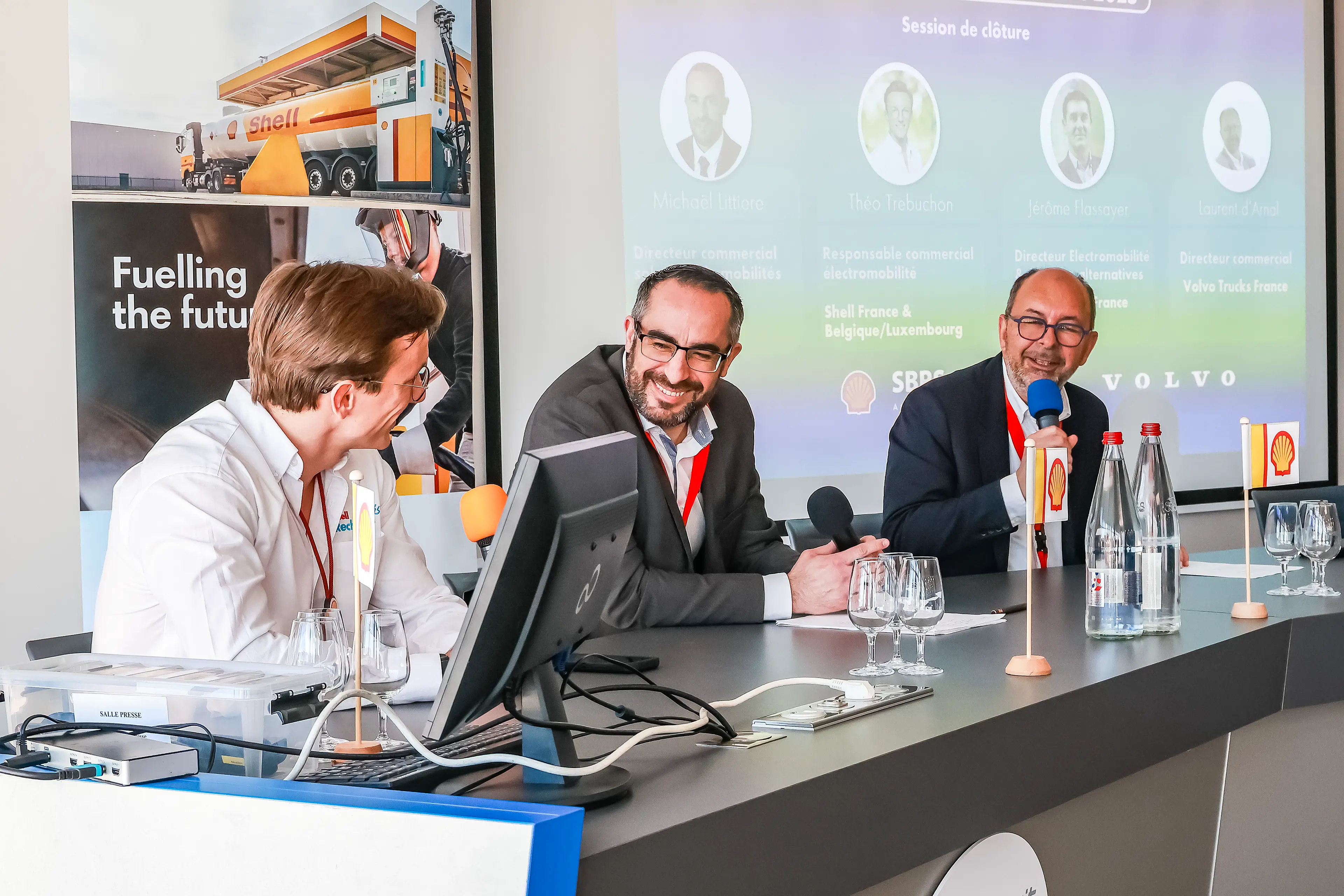 Hommes salariés Shell souriants présentant une conférence sur les carburants alternatifs