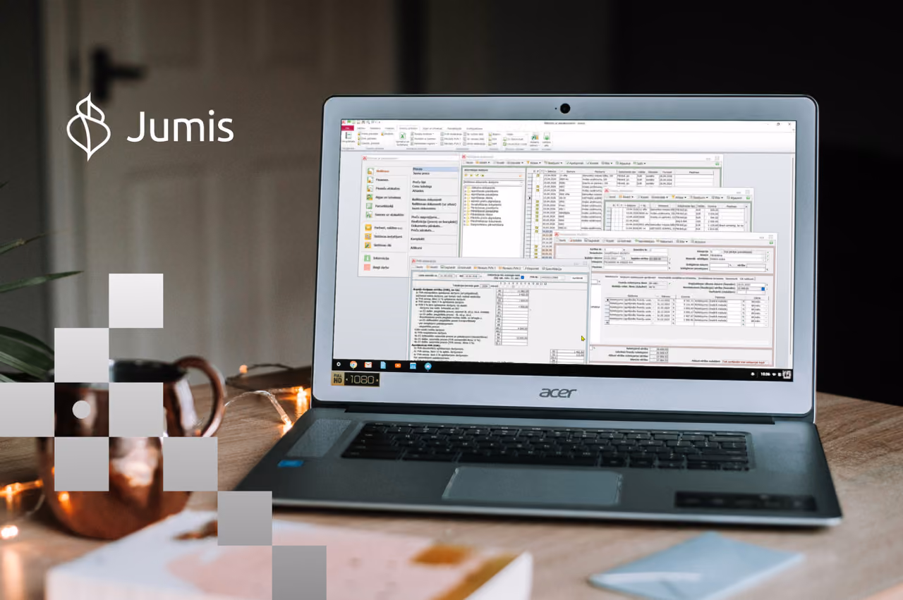 An open laptop sitting on a table showing Jumis by Visma accounting software open on it.