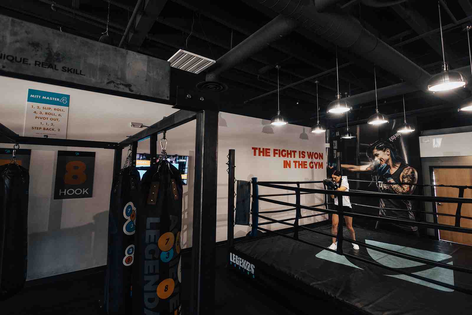 of a classic boxing gym with a ring and heavy bags - boxing gym utah
