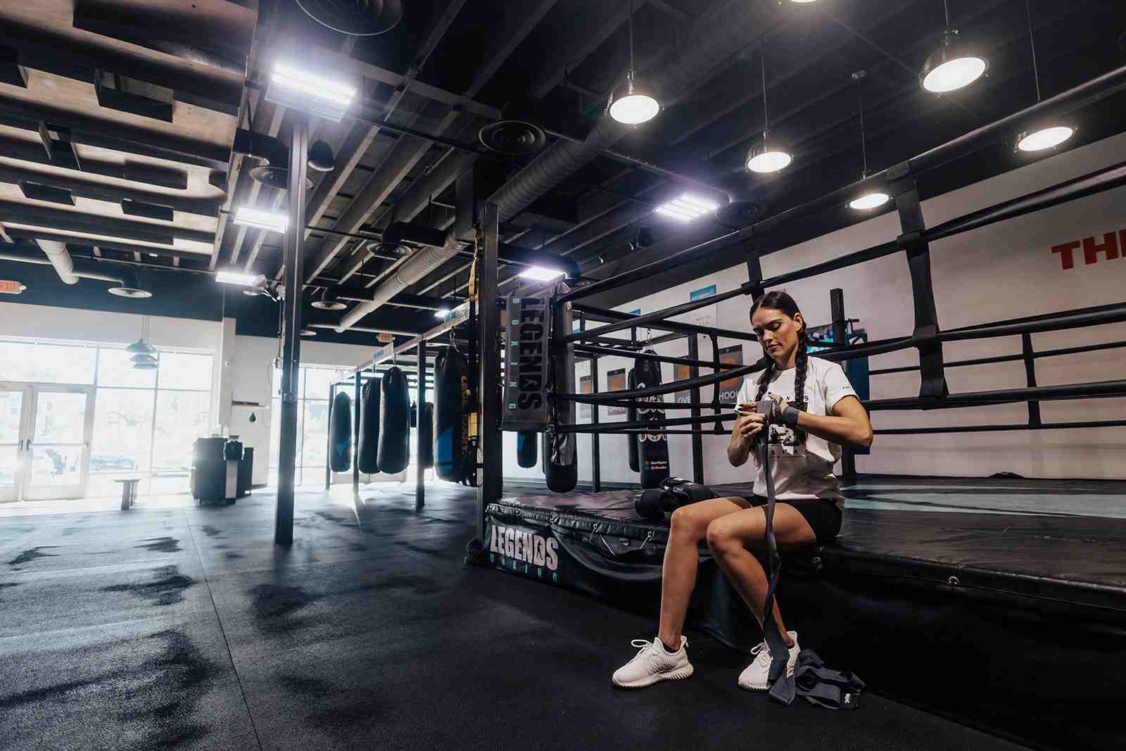 of a person smiling and wrapping their hands before a workout - boxing gym utah
