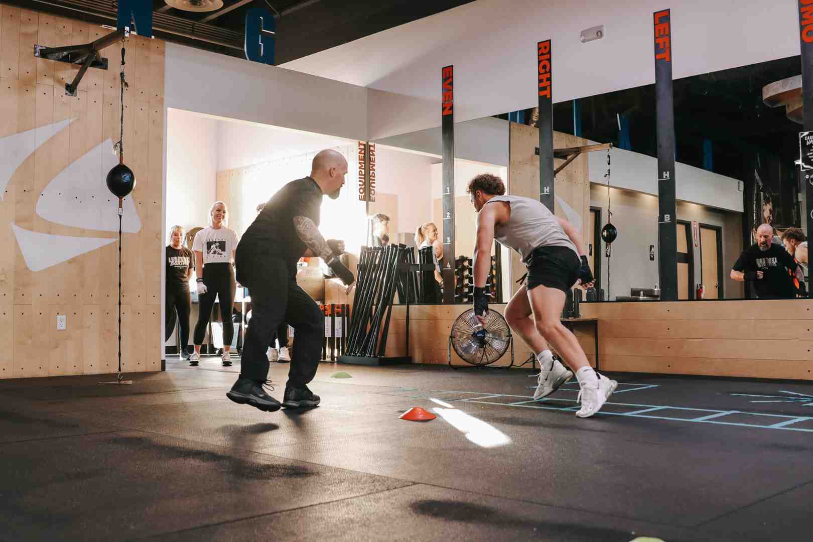coach giving one-on-one instruction to a beginner - boxing classes salt lake city