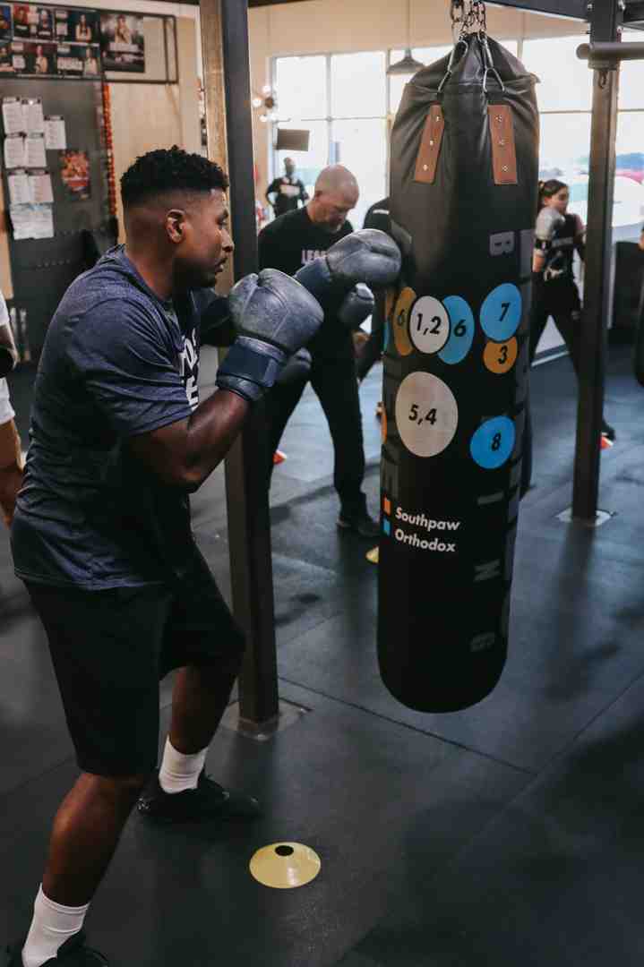 person hitting a heavy bag with proper form - salt lake city boxing