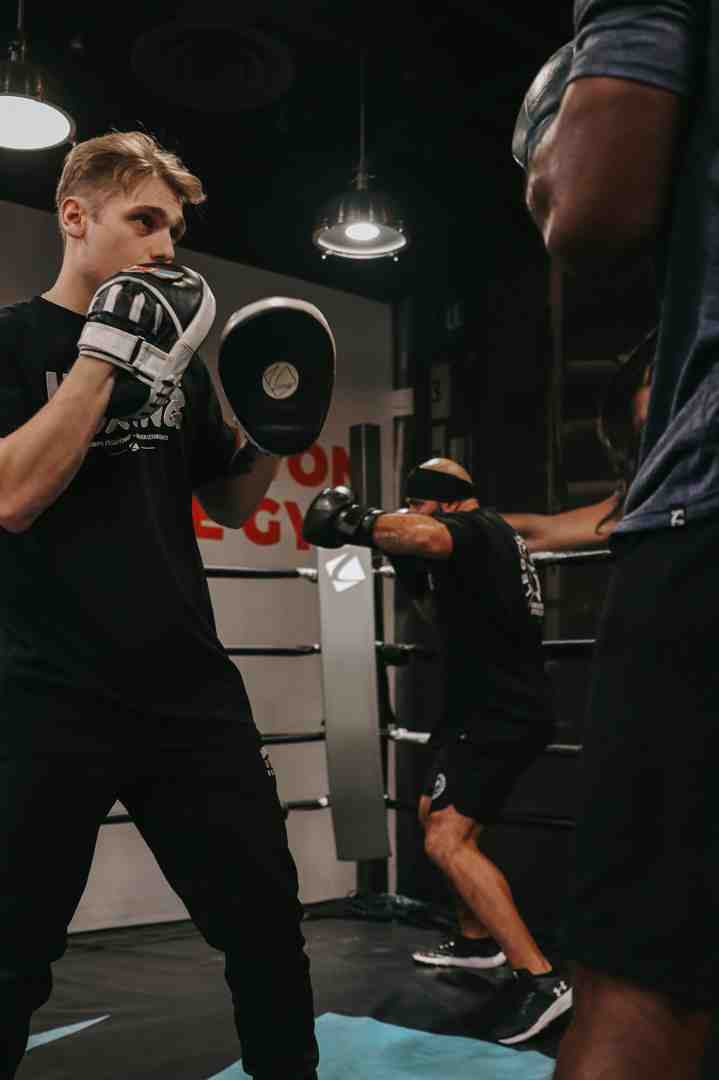 coach holding mitts for a member - boxing gym layton utah