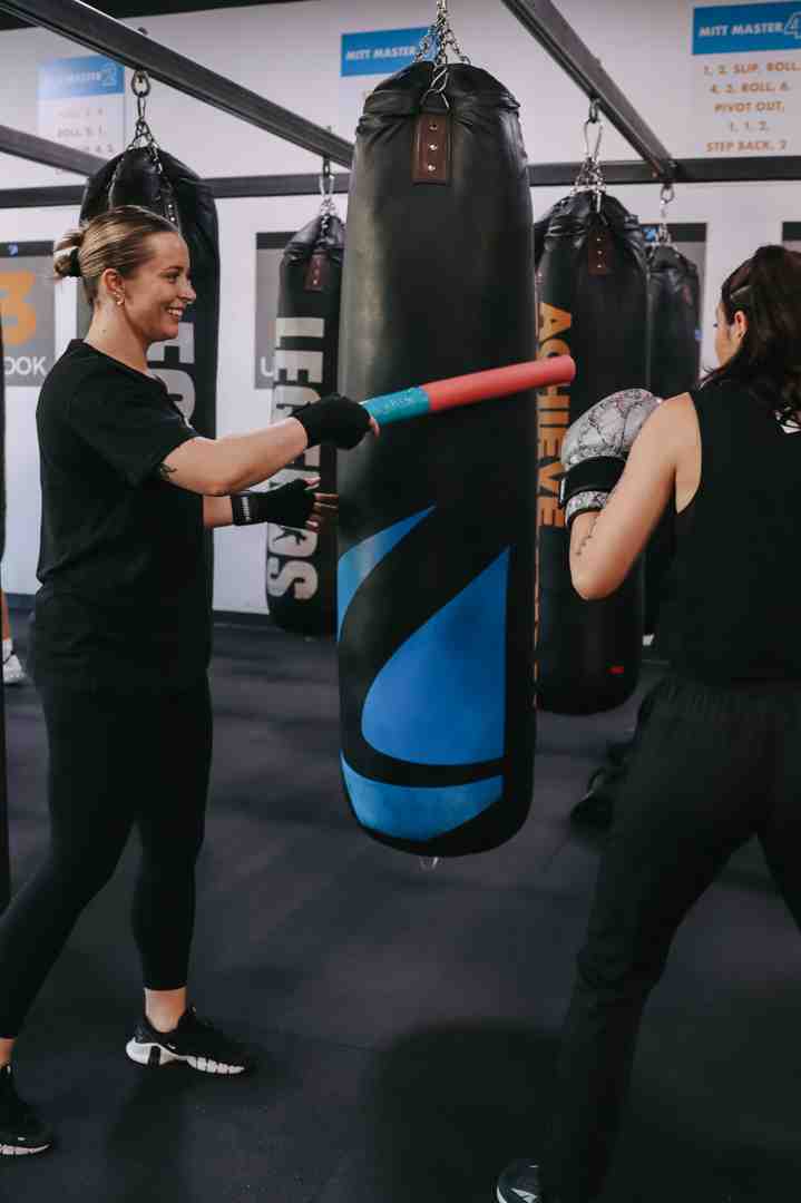 person hitting a heavy bag - boxing and conditioning classes person hitting a heavy bag - boxing and conditioning classes