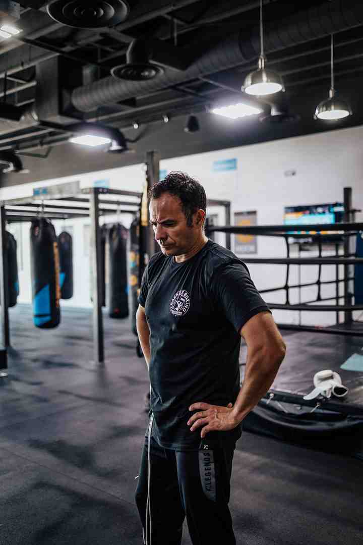 clean, well-lit gym with rows of heavy bags - gym with punching bag