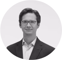 A man wearing glasses and a suit.
