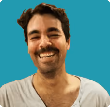 A man with a beard and mustache smiling at the camera.