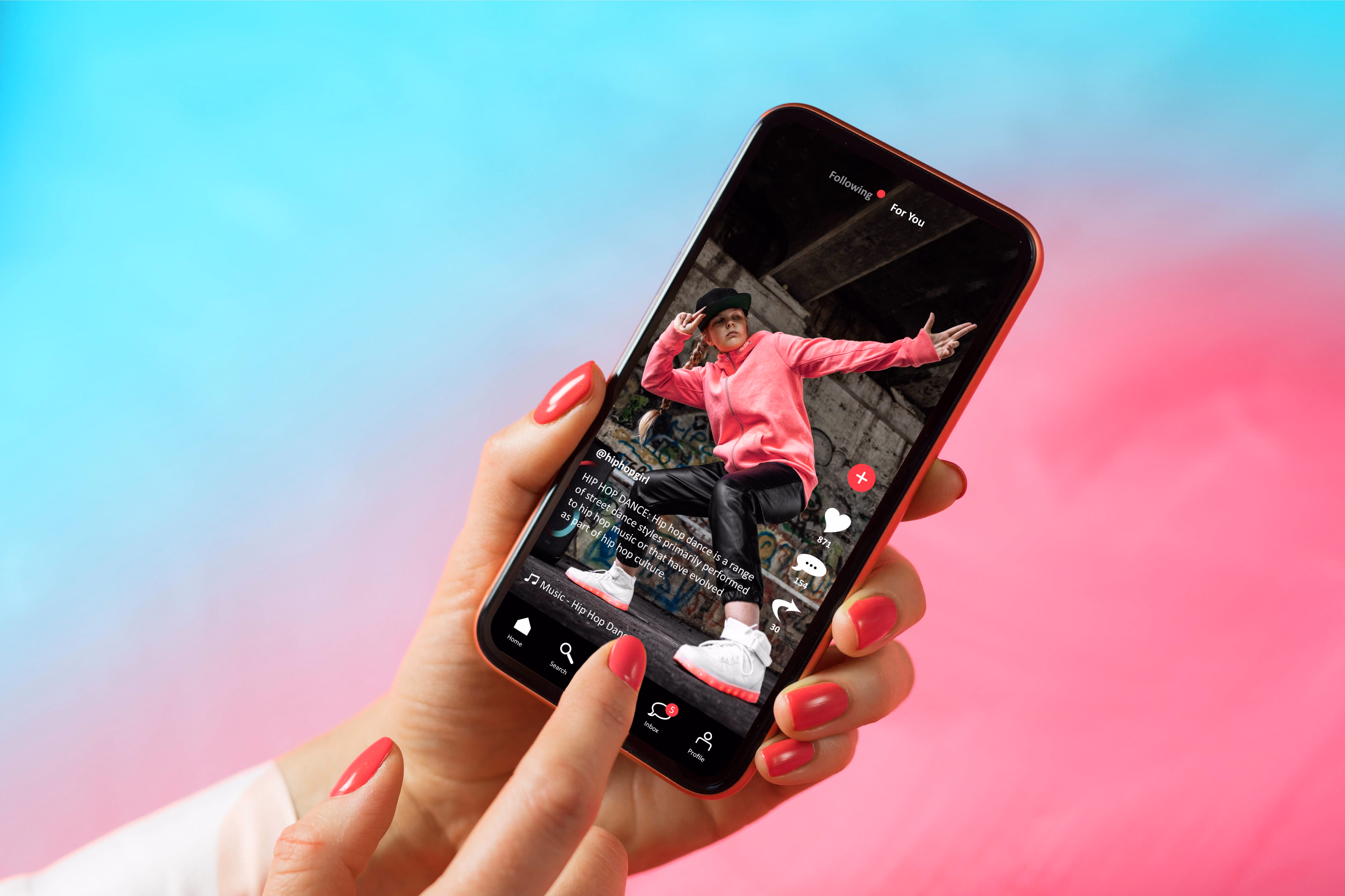 A person holding a cell phone with a picture of a man on it, in the tiktok app.