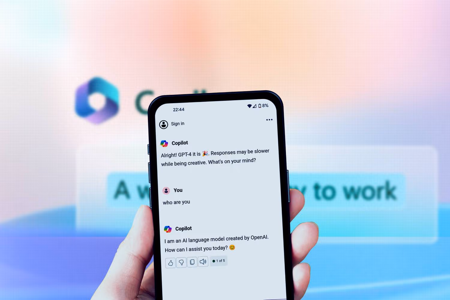 A person holding a cell phone with a message on the screen, showing the Copilot Ai from Microsoft.