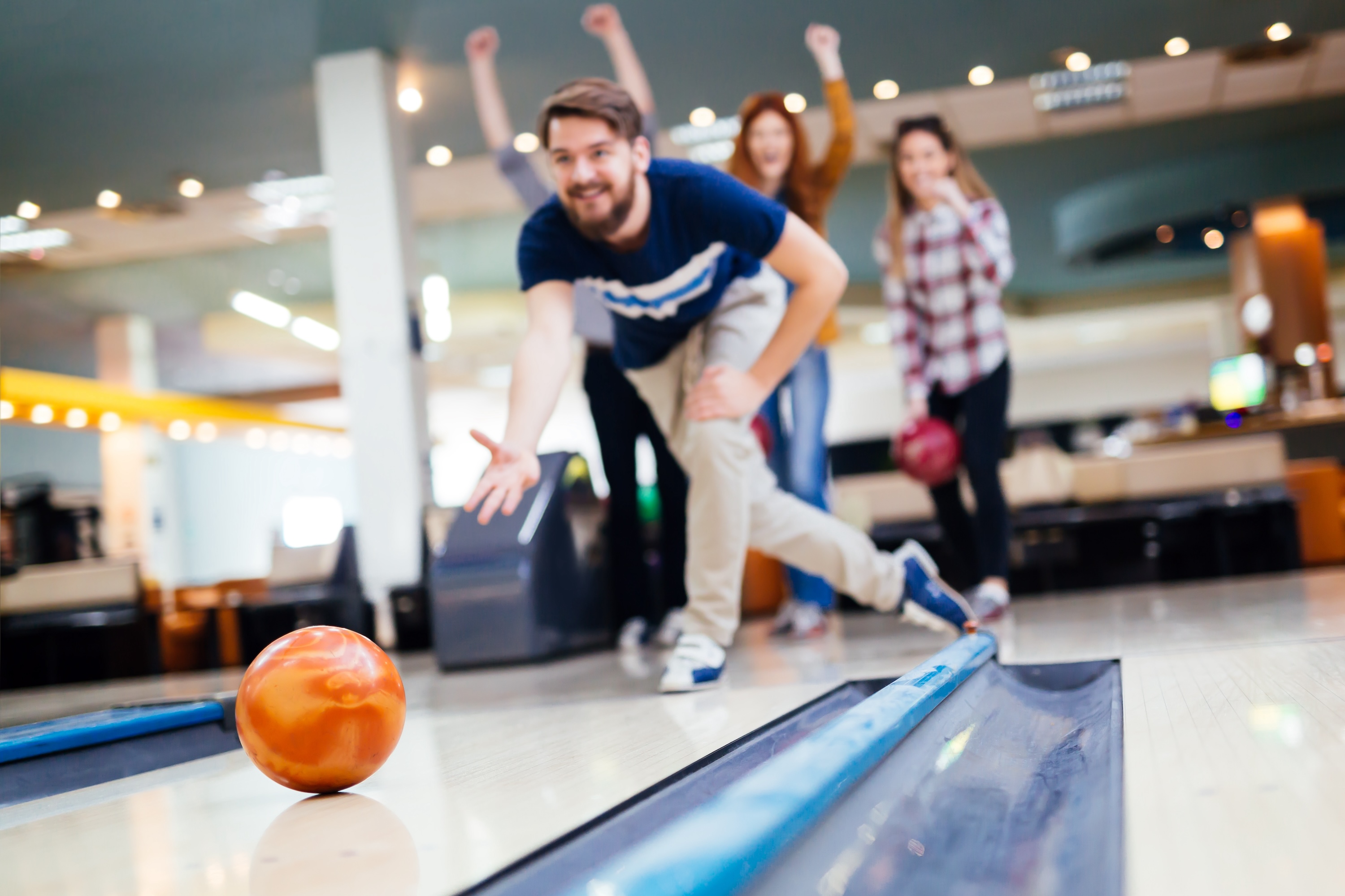 Group of friends enjoying an afternoon of bowling near Global College Station in College Station, Texas.