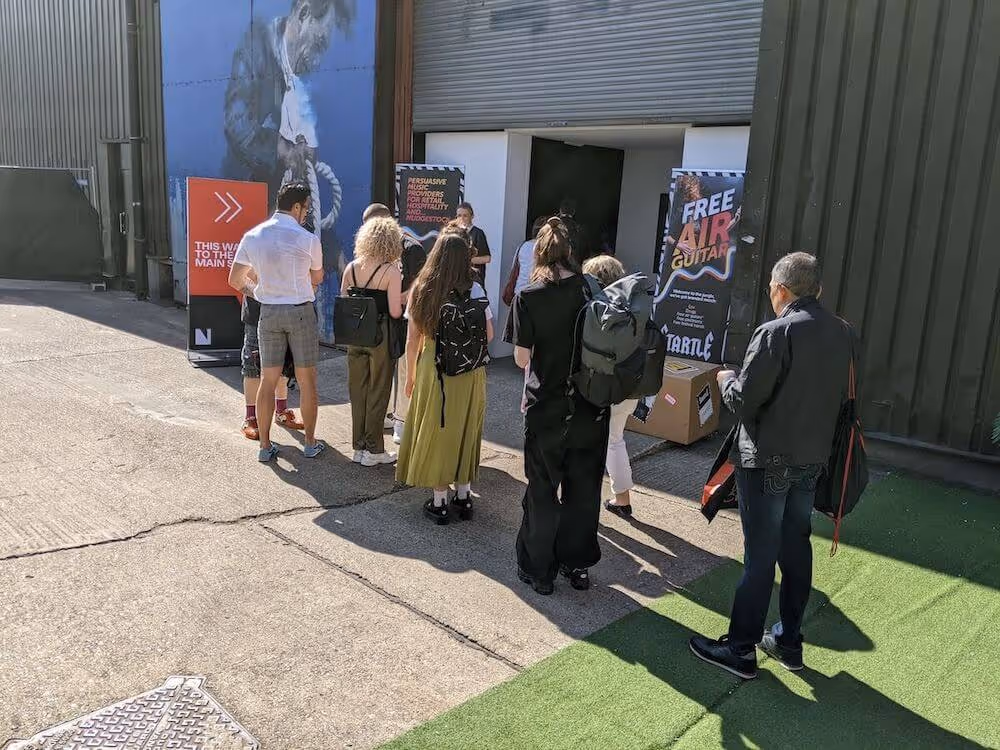 People queueing to get into Nudgestock, Startle banners either side of entrance