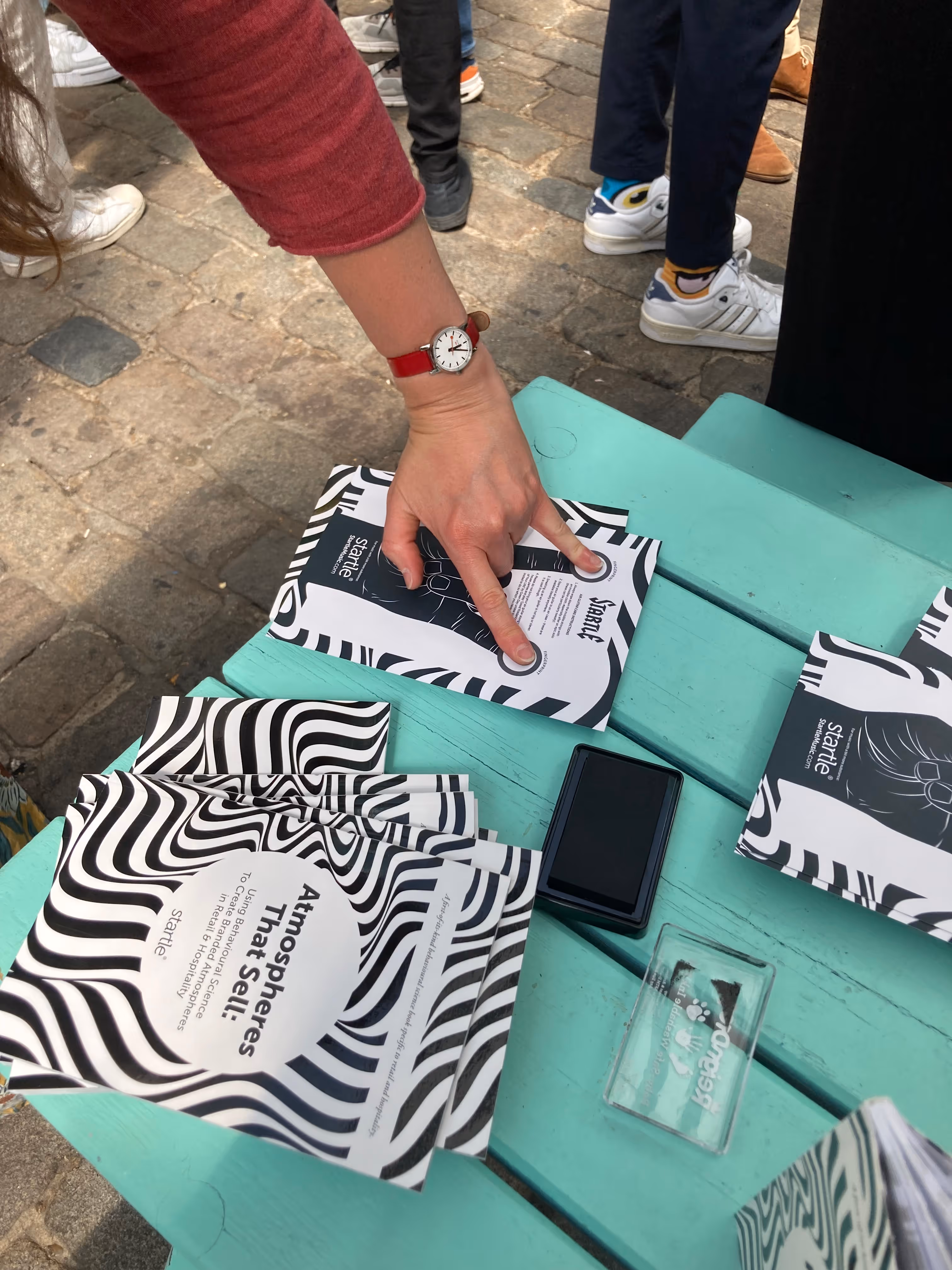 Close up shot of hand placing index and little fingers on the air guitar instructions sheet