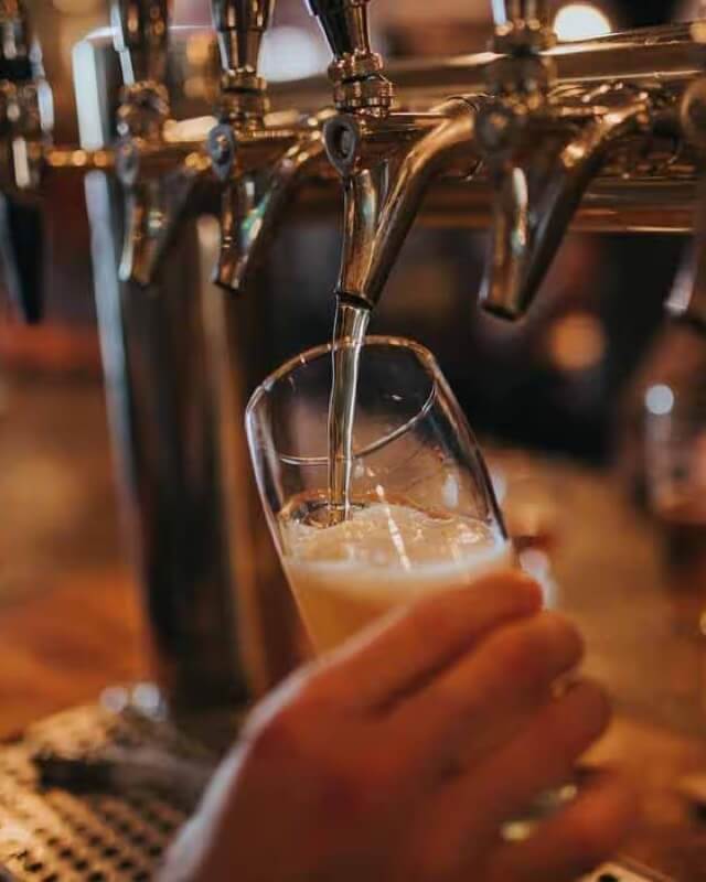 A pint of lager being poured
