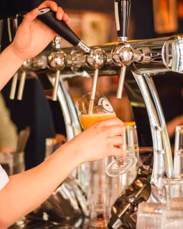 A pint of lager being poured