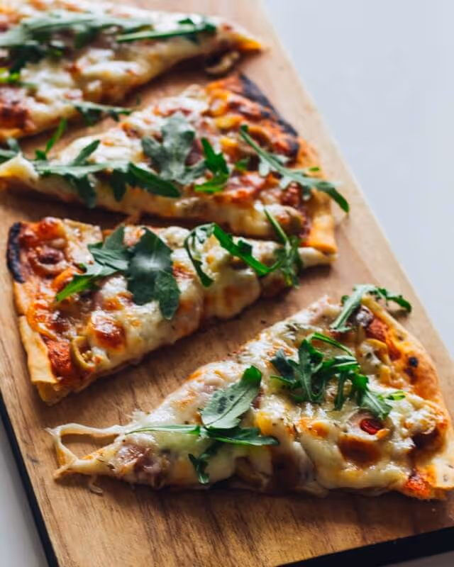 Three slices of pizza on a chopping board