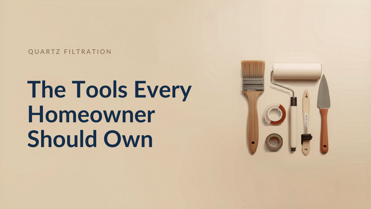 Flat-lay of essential painting tools for homeowners: angled brush, roller, tray, painter's tape and putty knife.