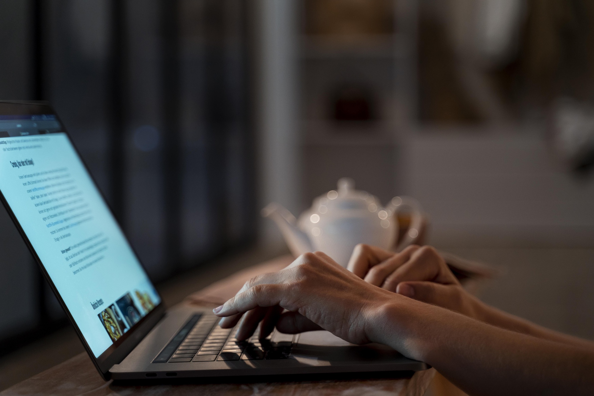 Typing on a black laptop.