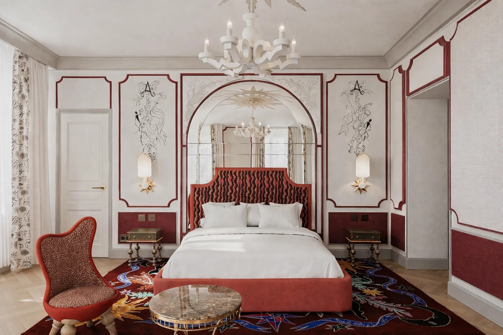 Chambre de L’Aventure avec lit à tête de lit rouge et fauteuil assorti.