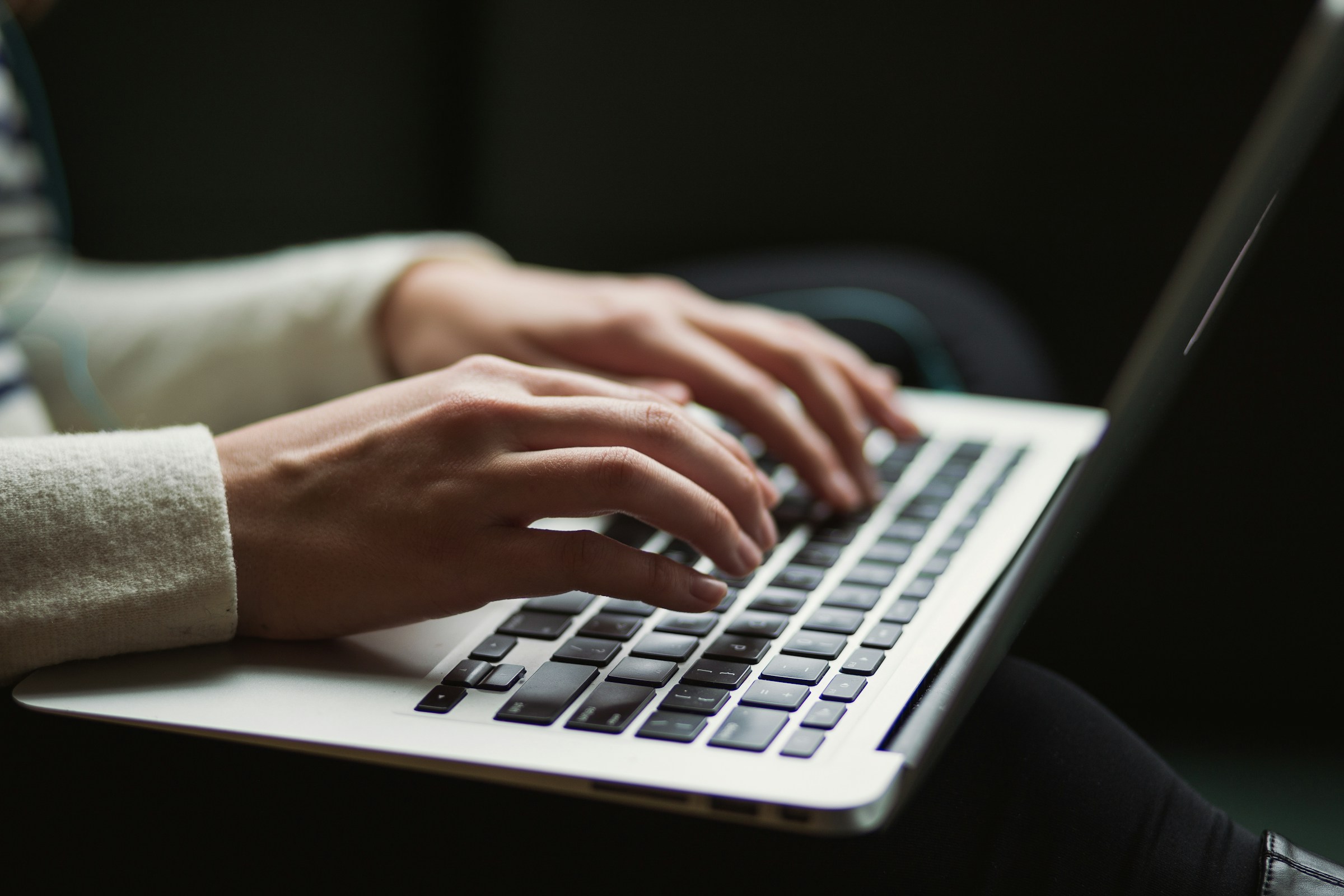 woman typing on a laptop - LinkedIn Personal Branding