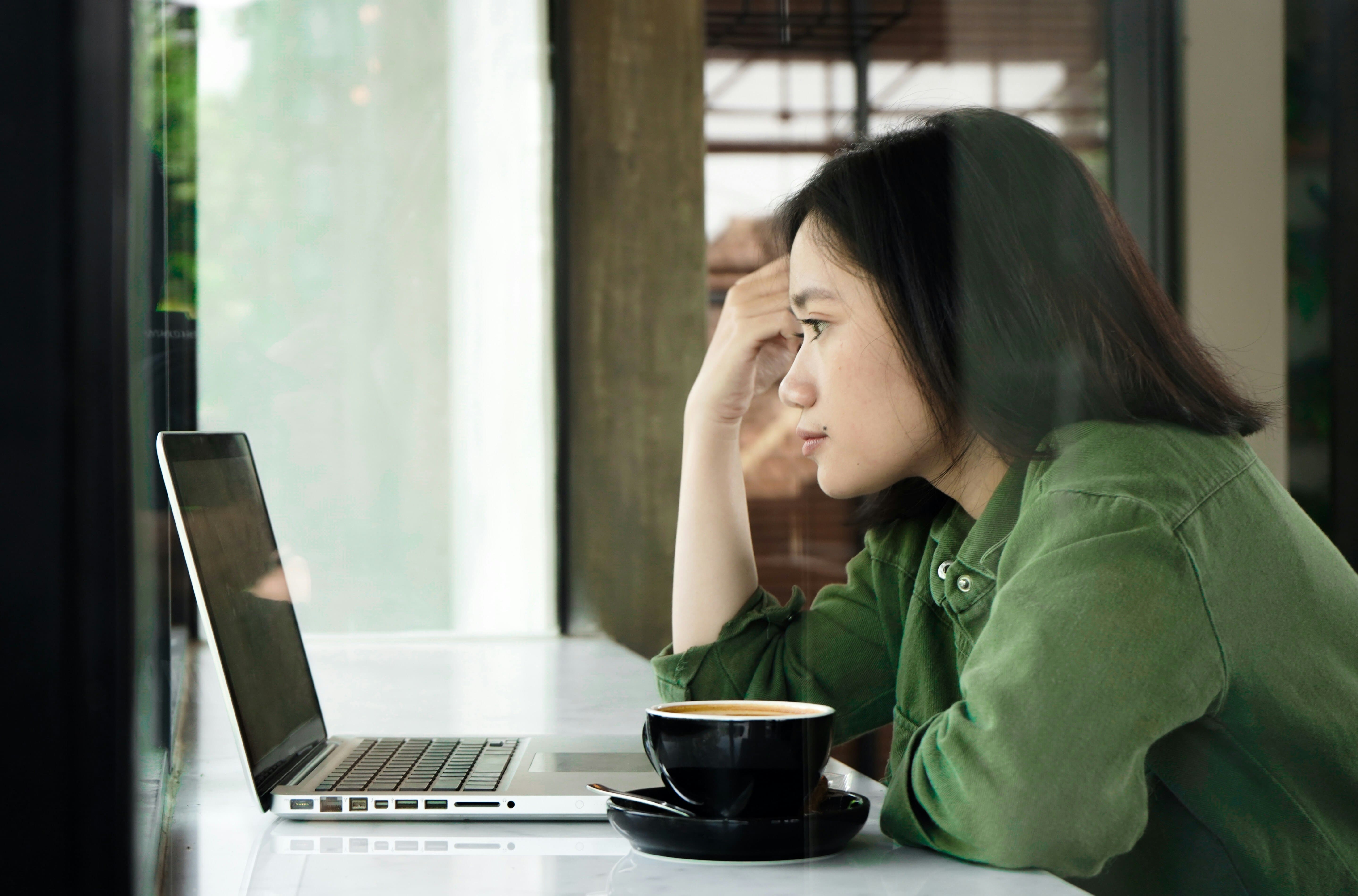 woman looking at a laptop - Taplio vs Supergrow