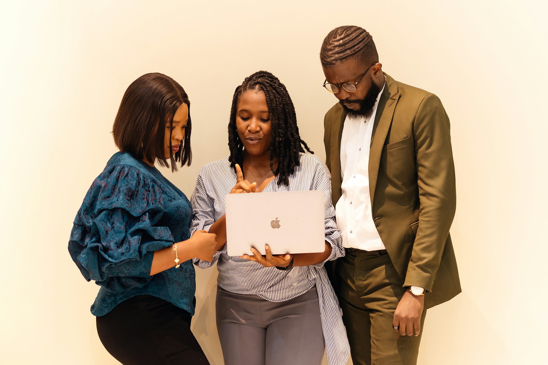 employees holding a laptop - LinkedIn Post Examples