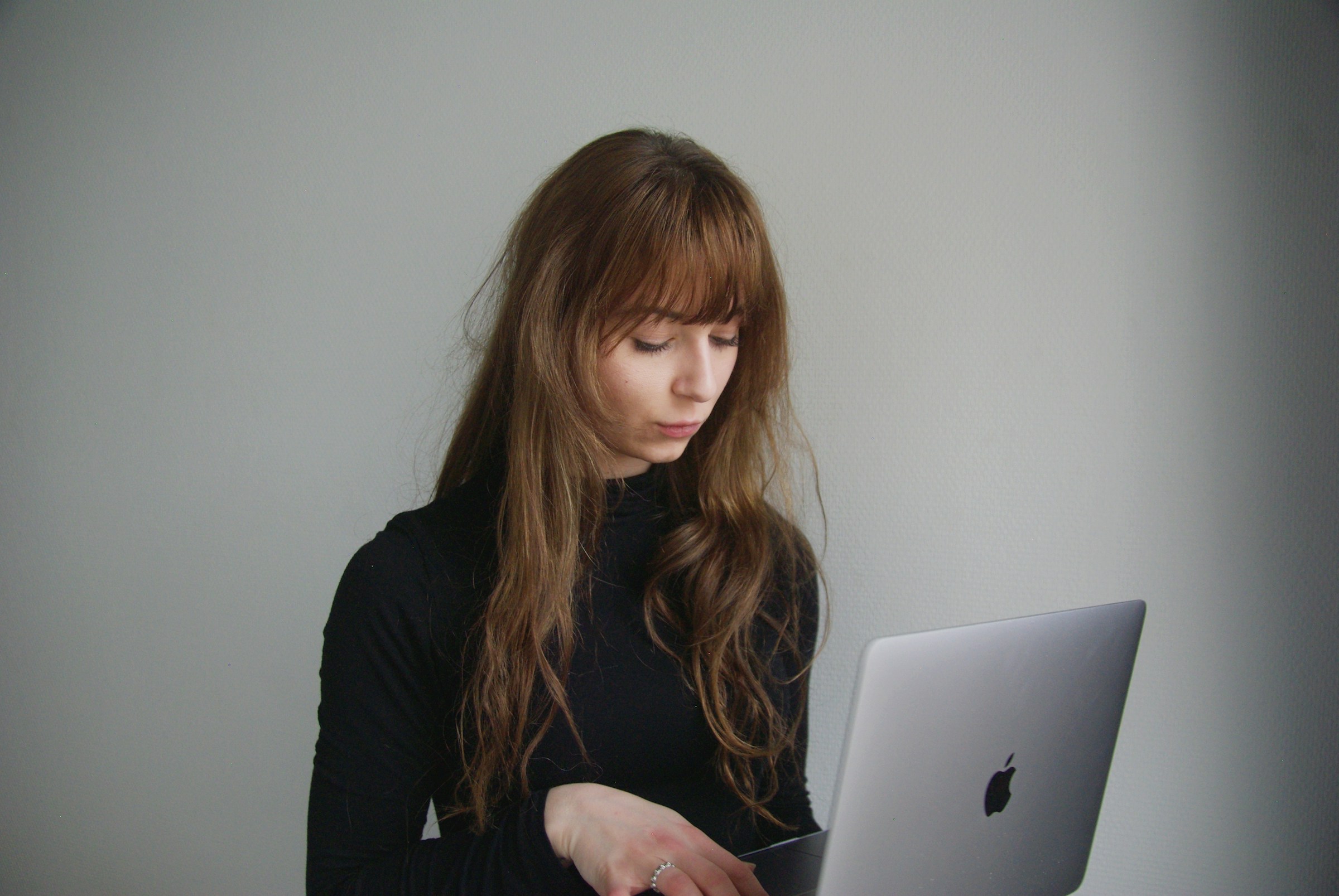 woman holding a laptop - Turn Off Looking for Job LinkedIn