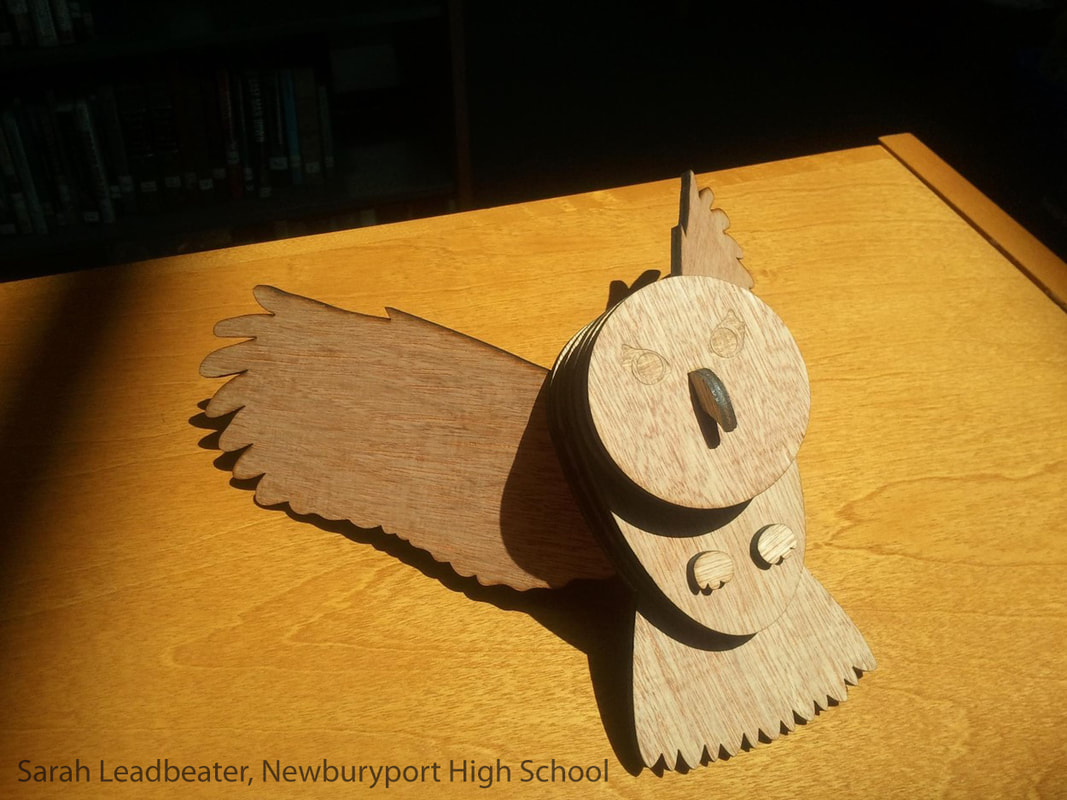 Wooden owl figurine with wings and closed eyes on yellow surface.