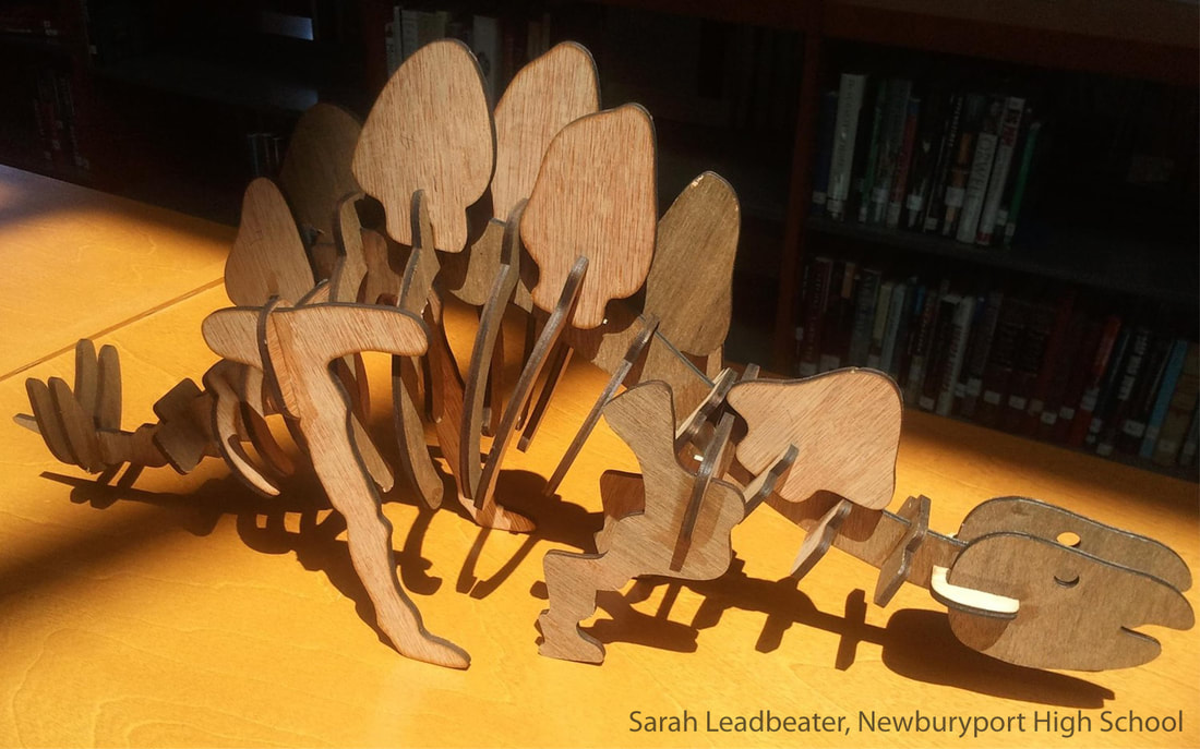 Wooden creatures displaying detailed shadows on yellow surface, created by Sarah Leadbeater