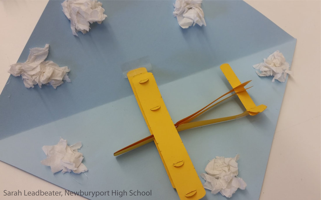 Yellow paper airplane surrounded by crumpled white paper balls on blue surface