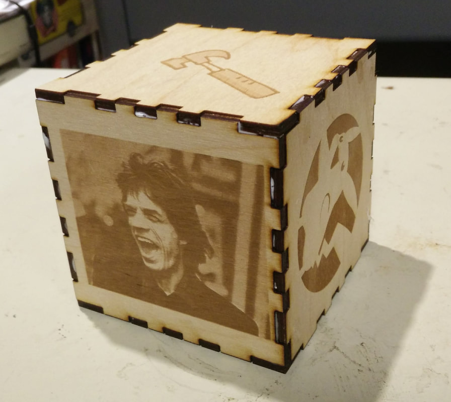 Wooden engraved box with rock star portrait and decorative designs