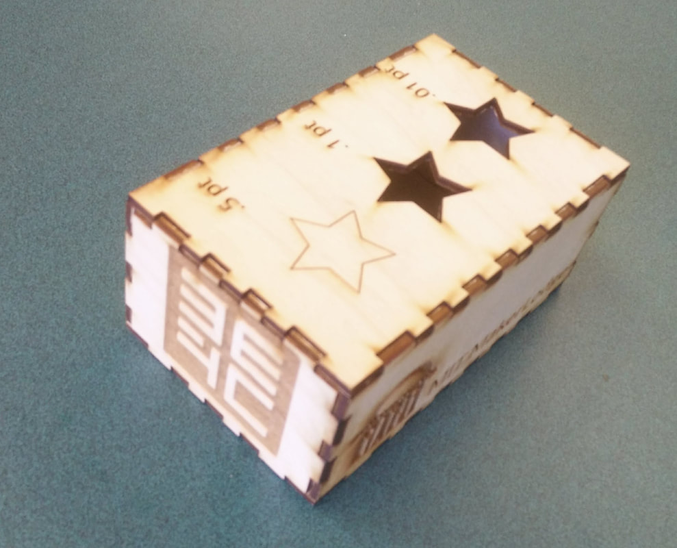 Decorative wooden box with star cutouts on cream-colored top, displayed at angle