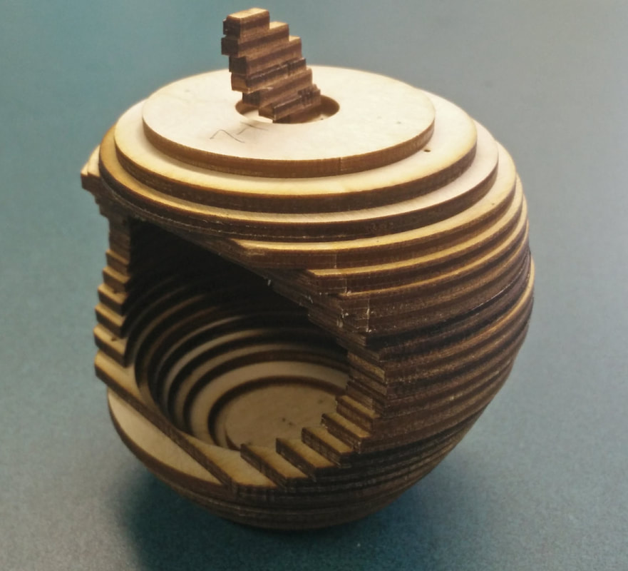 Wooden decorative vessel with layered dark and light stripes and matching lid finial.