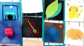 Children's artwork displayed on wall: blue house, leaf drawing, Pikachu, and dog portrait