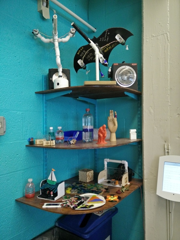 With a just few brackets and plywood sheets, this previously unusable corner became a showcase for favorite projects.