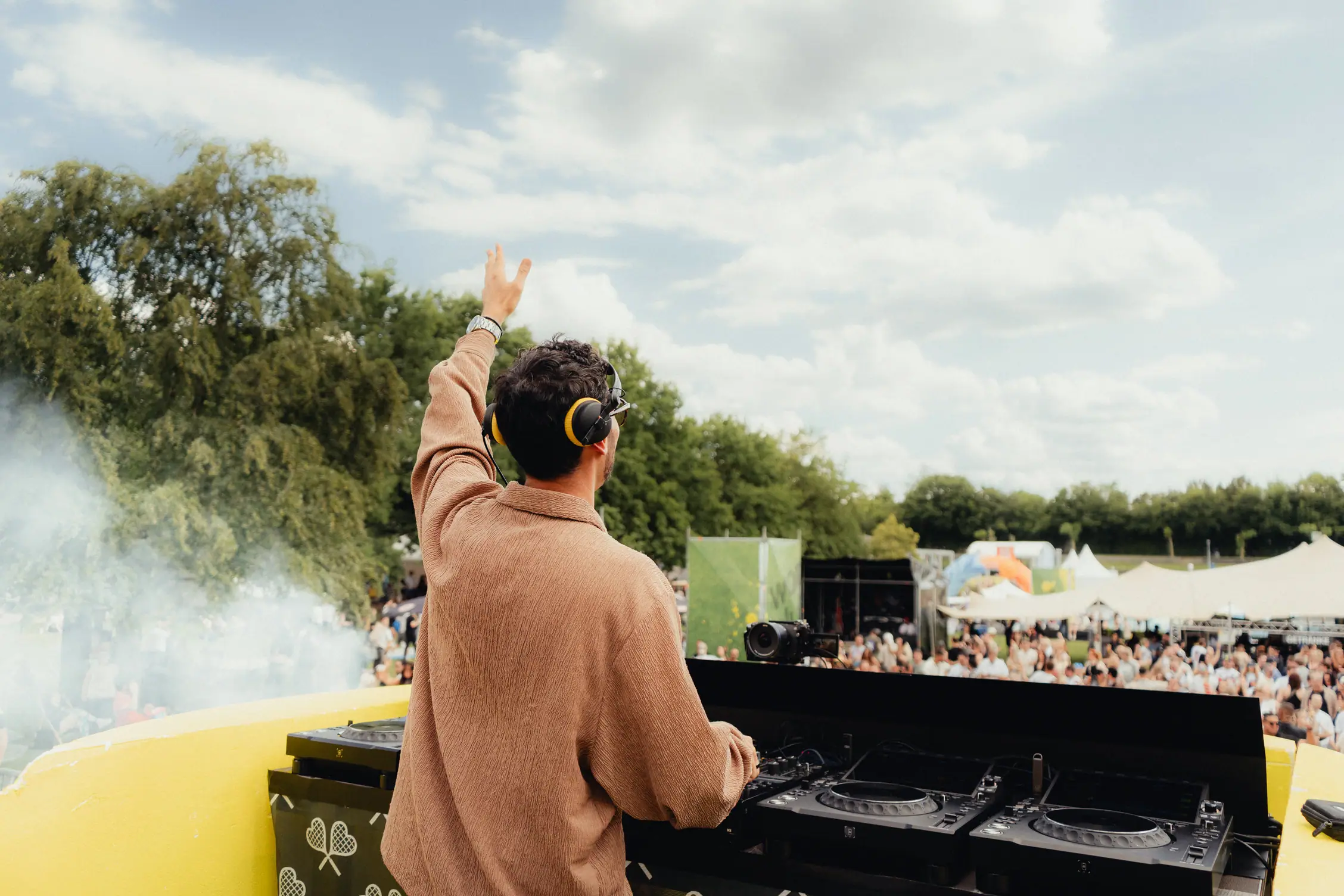 Dj performing at outdoor festival.